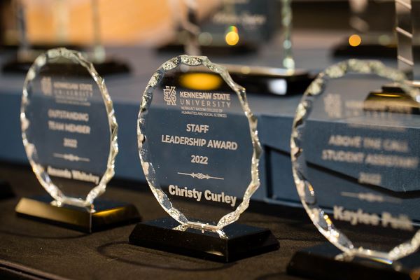 Three KSU trophies sitting on a table
