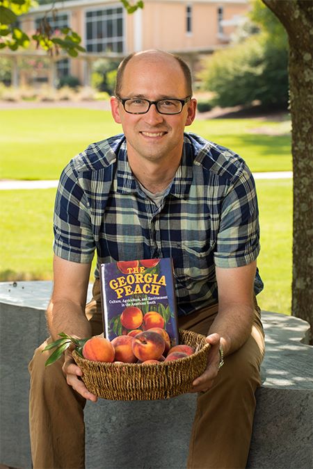 Tom Okie, holding a basket of Georgia peaches