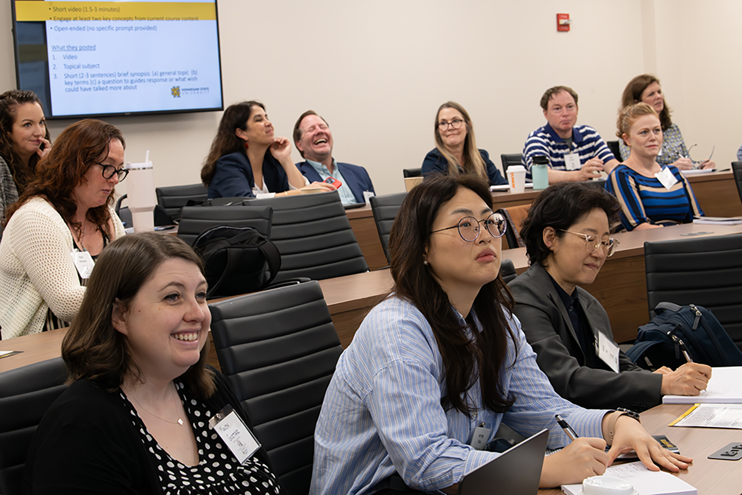Breakout room at student summit. Some attendees are laughing.