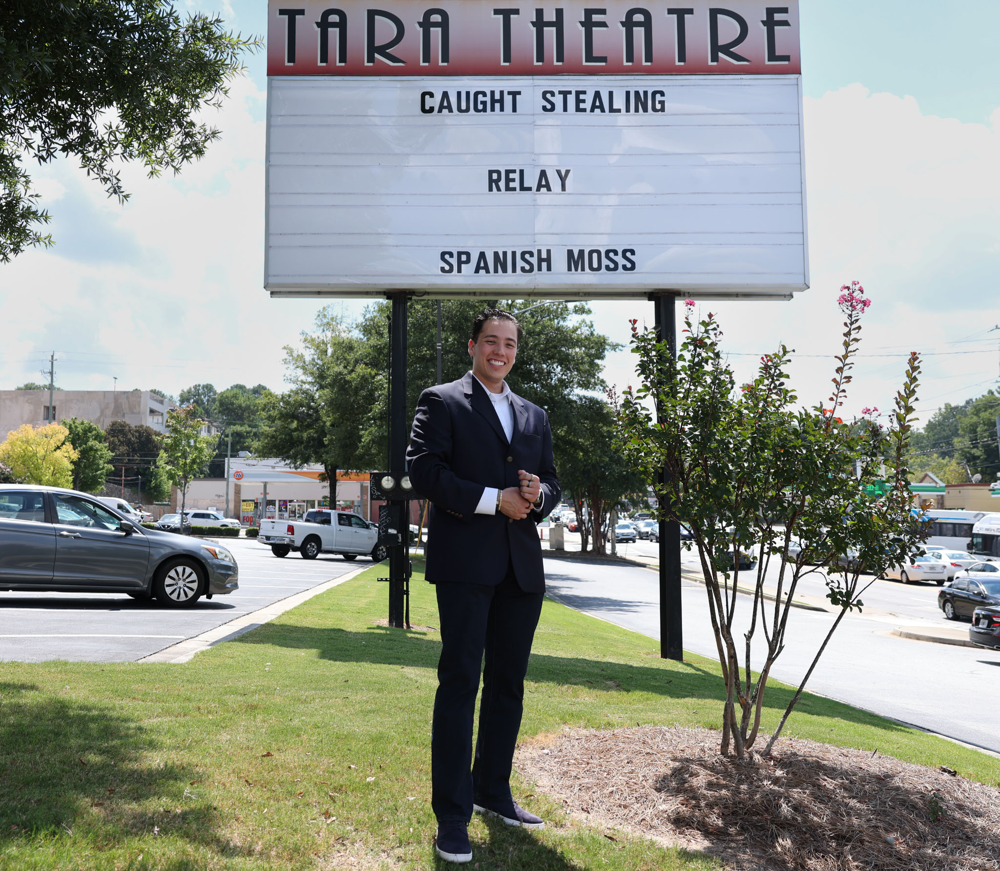 KSU alumnus Sebastian Soler stands in front of a theater marquee promoting his first feature film, Spanish Moss.