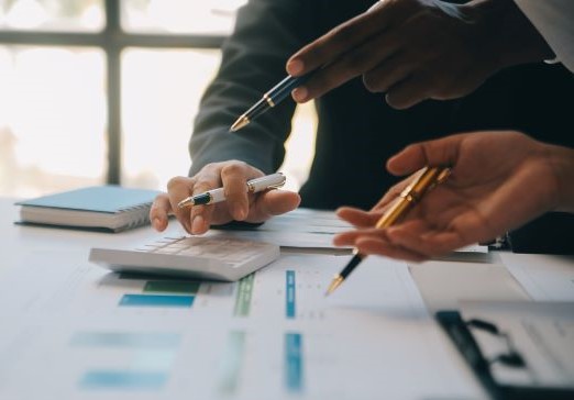 Business team working with new startup project plan and discussion information for financial strategy with laptop and digital tablet in a modern business lounge.