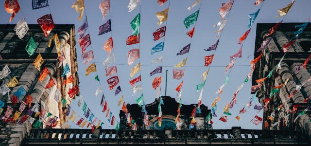 Colorful flags fluttering in front of a building