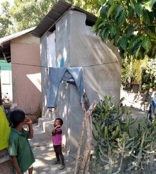  / two-story concrete building with a corrugated roof.