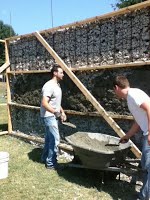 Concrete added to cover rubble and mesh on building structure