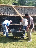 Concrete added to cover rubble and mesh on building structure