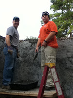 Concrete added to cover rubble and mesh on building structure