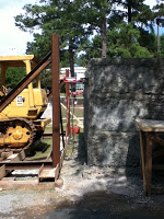 Concrete added to cover rubble and mesh on building structure