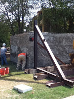 Concrete added to cover rubble and mesh on building structure
