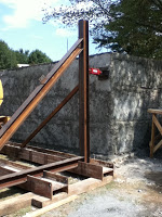 Concrete added to cover rubble and mesh on building structure