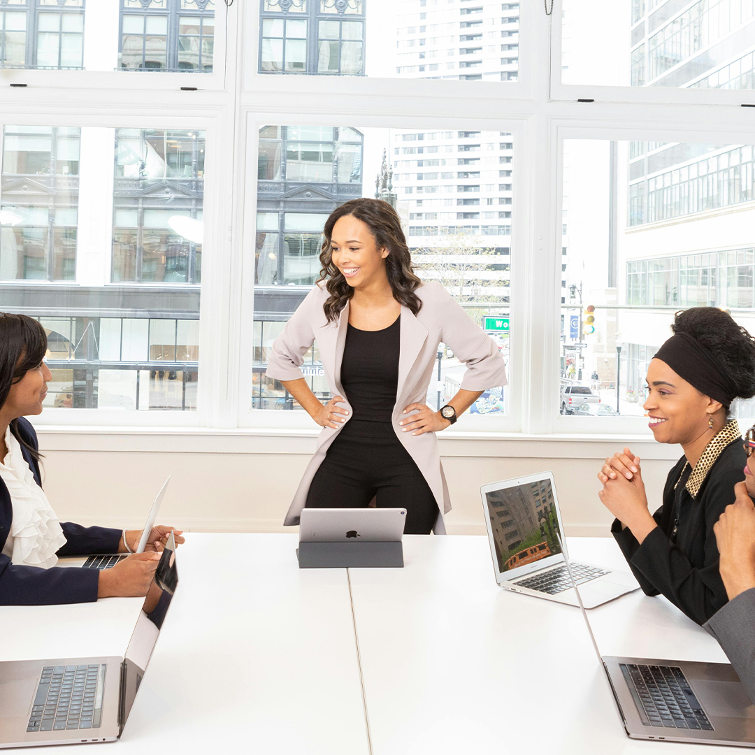 female boss in boardroom leading meeting