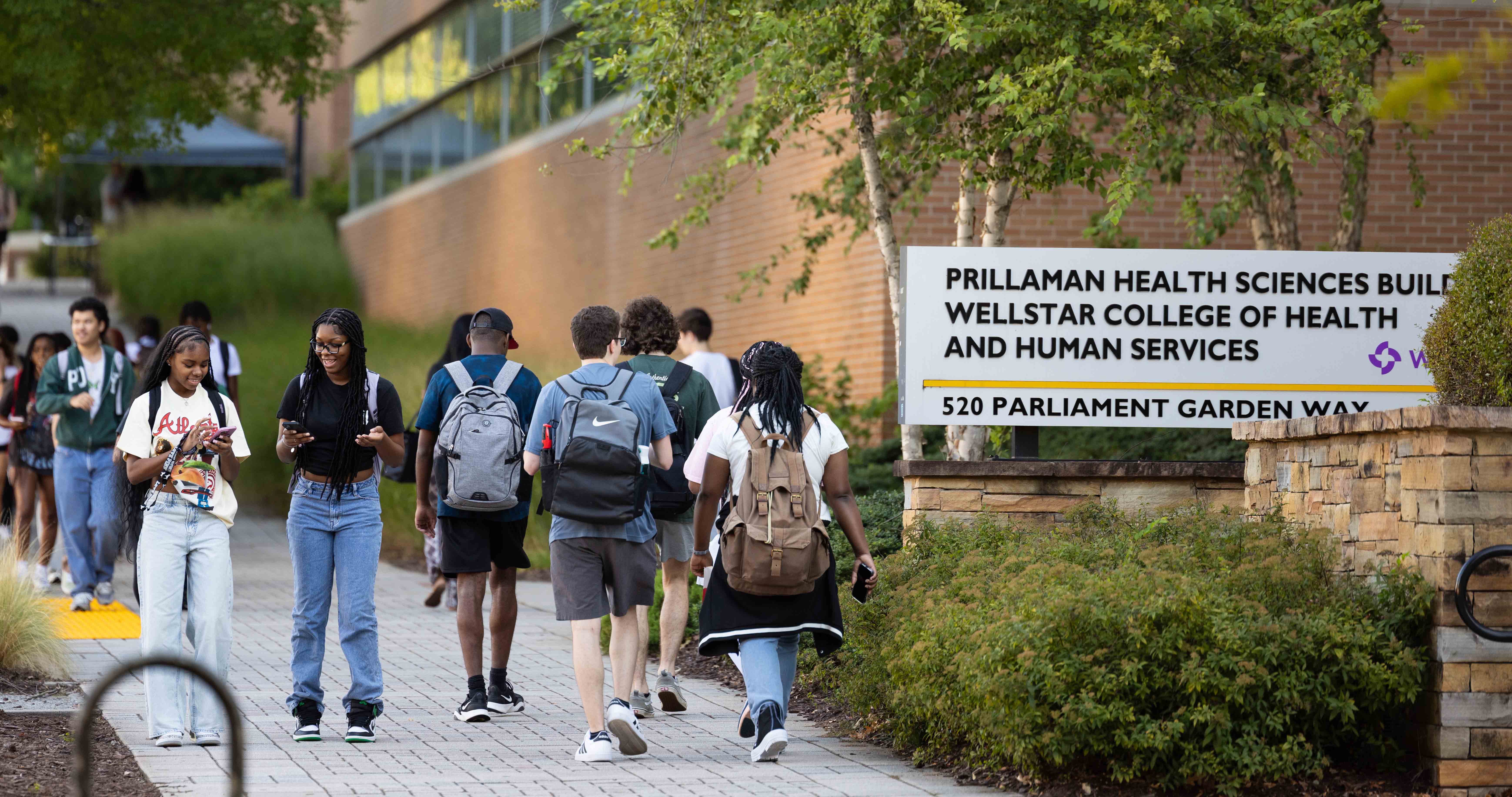SWHS faculty and students discussing research and creating brainstorming clouds on a whiteboard