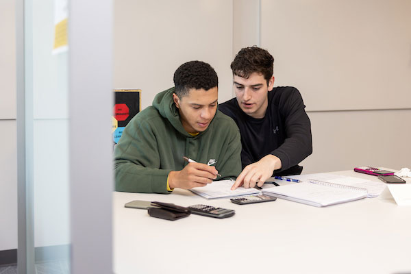 two students working together at table