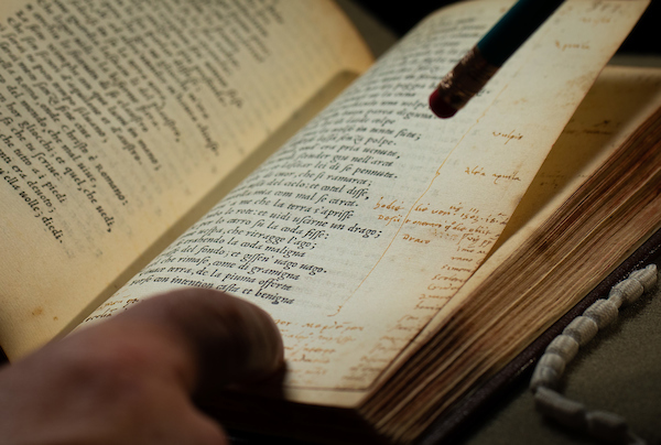 finger pointing to page in an open book