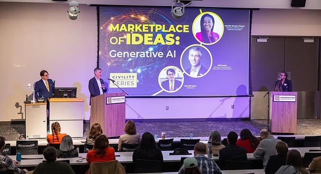 Three presenters on a stage talk about generative AI.