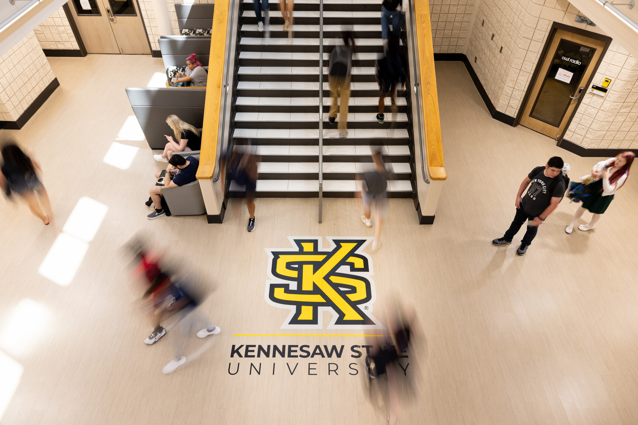students walking up and down the main staircase in the Student Center