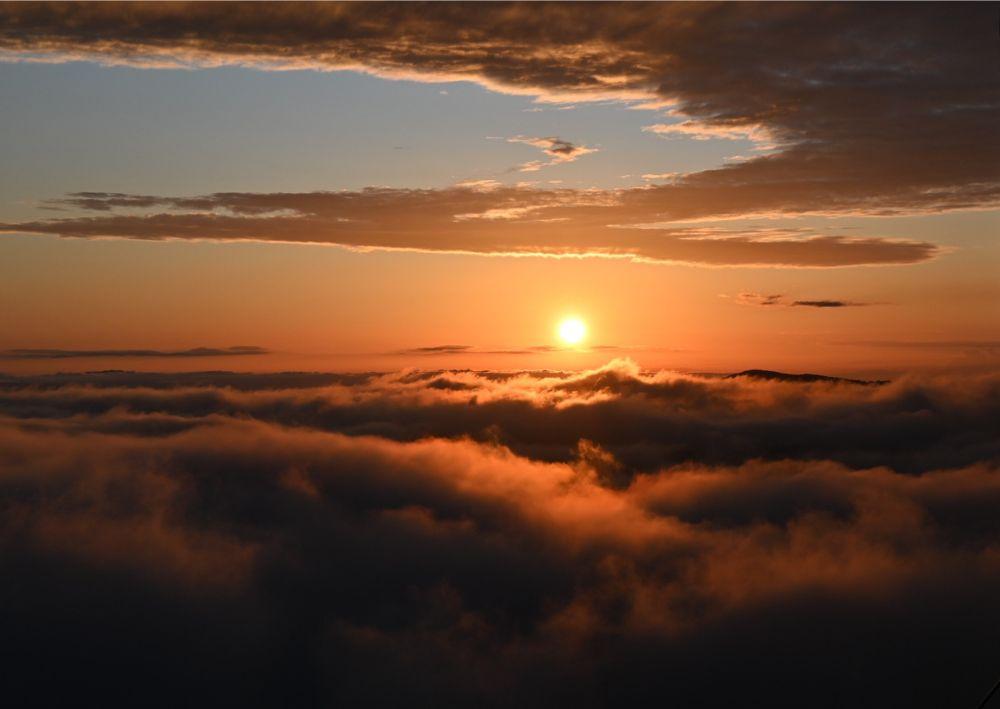  / Sunset through the clouds from an airplane