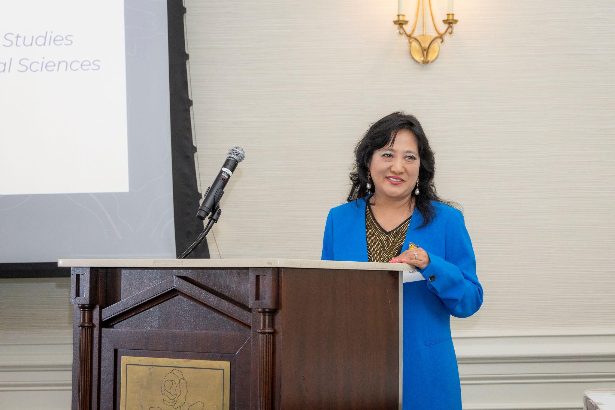 International Achievement Awards and Scholarship Ceremony 2026 / May Gao speaking behind a podium. 