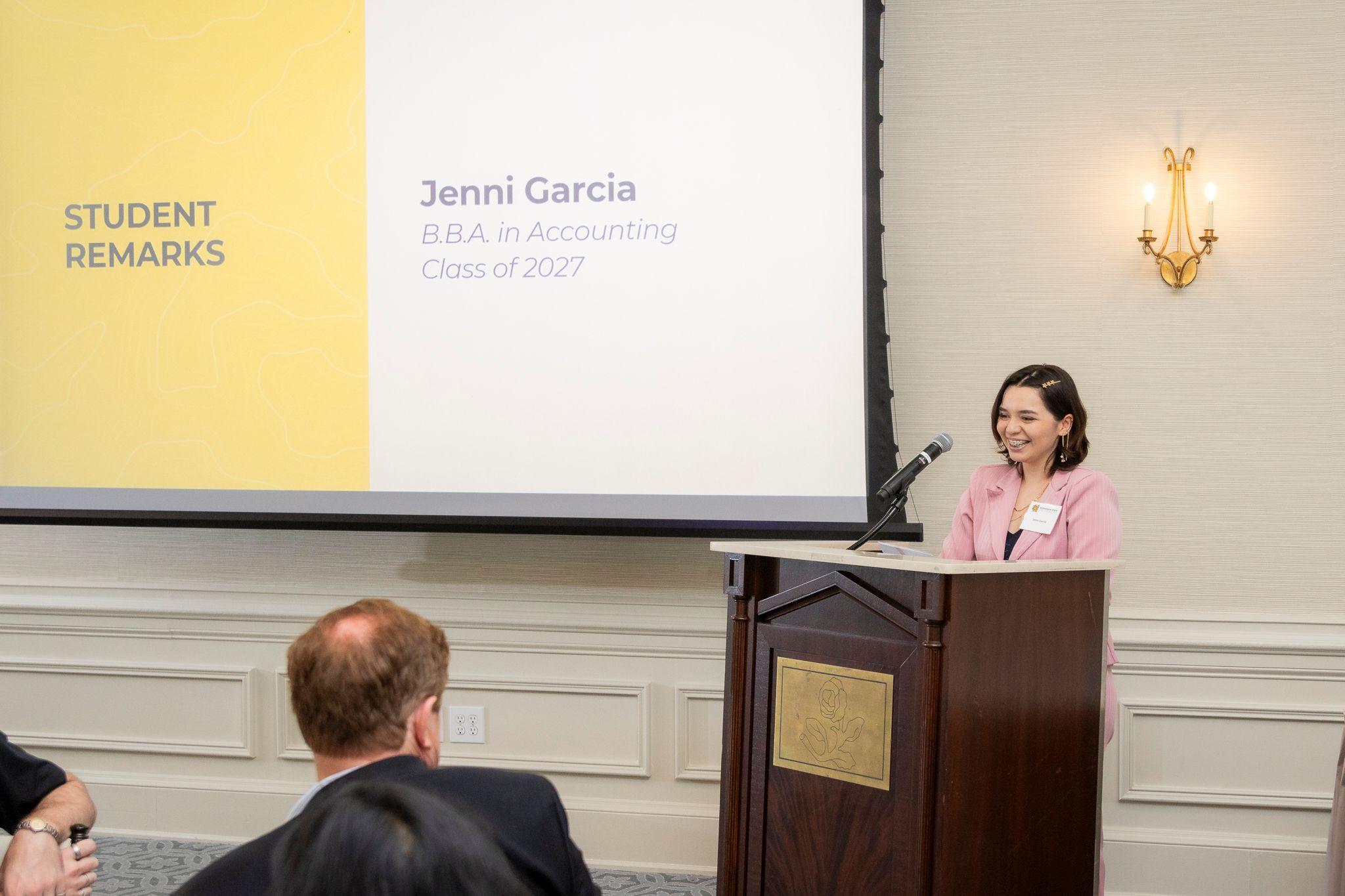 International Achievement Awards and Scholarship Ceremony 2026 / Jenni Garcia speaking behind a podium. 