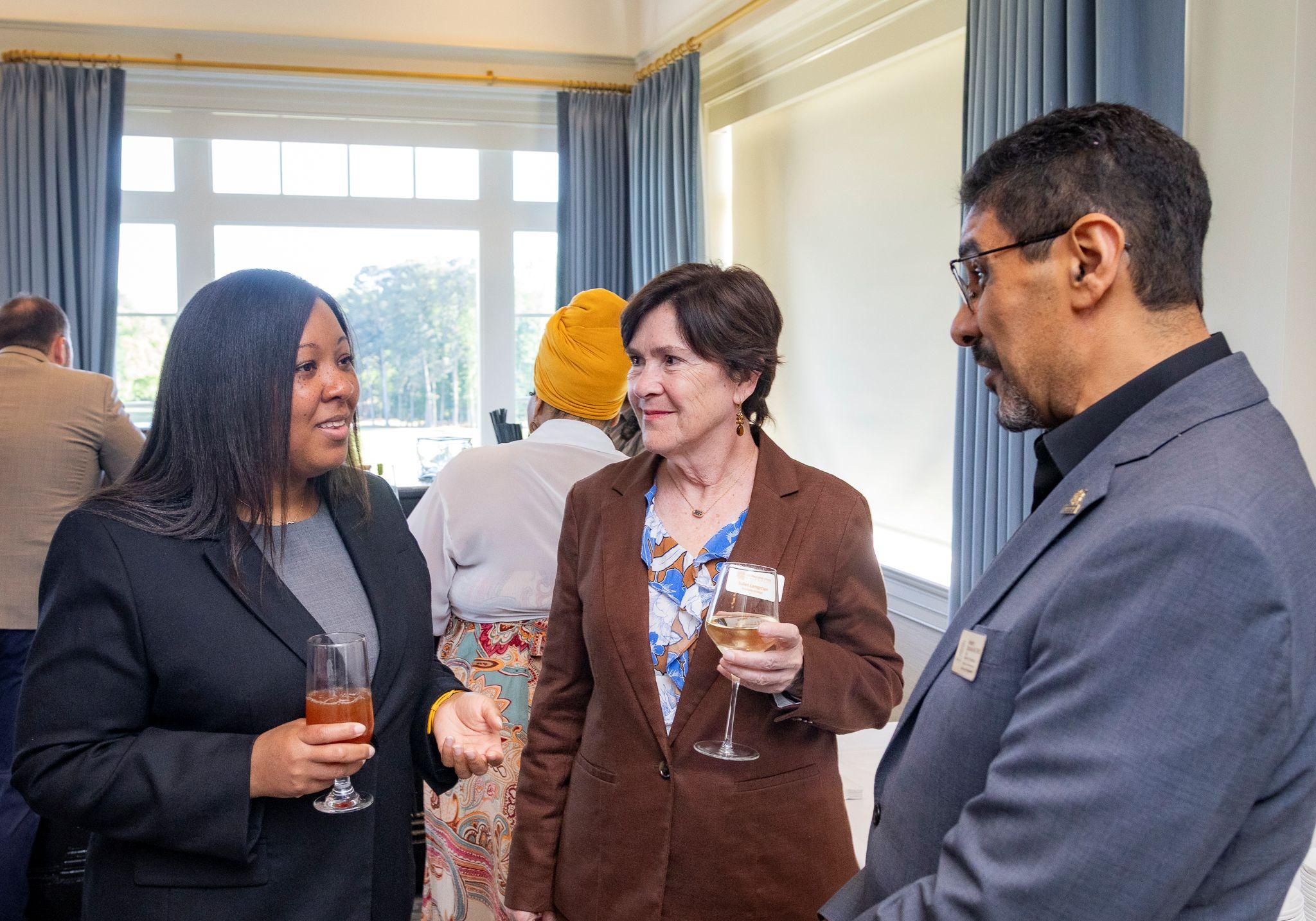 International Achievement Awards and Scholarship Ceremony 2026 / Ceremony attendees in a conversation.