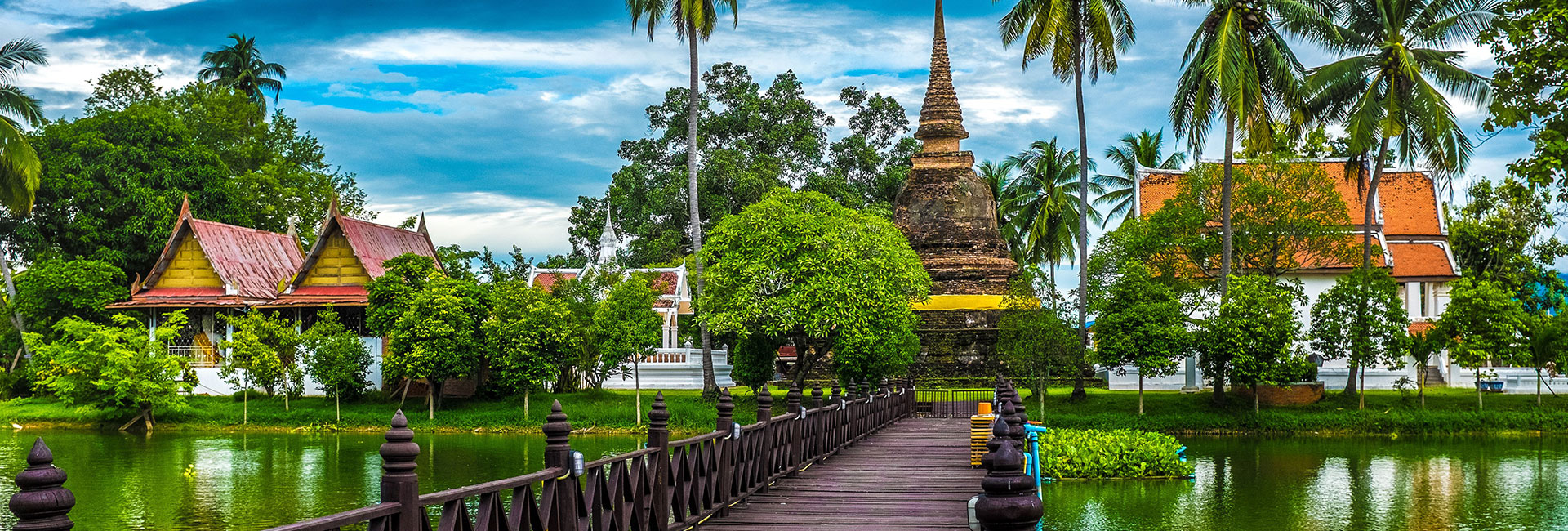 bridge leading to thailand buildings across water