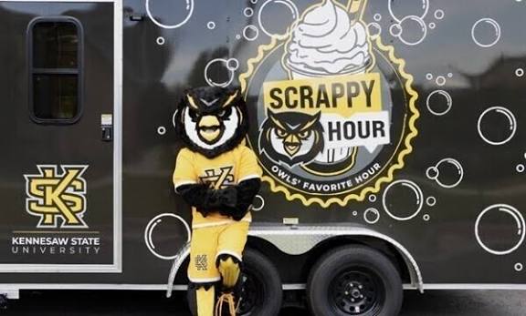 Scrappy standing in front of a truck