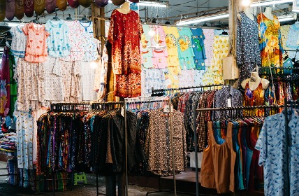 clothese hanging up for sale at a Thai market