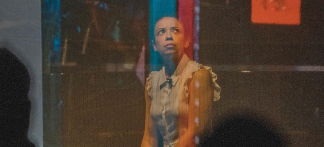 Looking through colored glass at the artist Mary Prescott