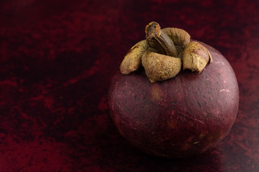 A mangosteen sitting on a table