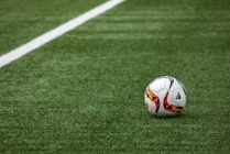 soccer ball resting on a soccer field
