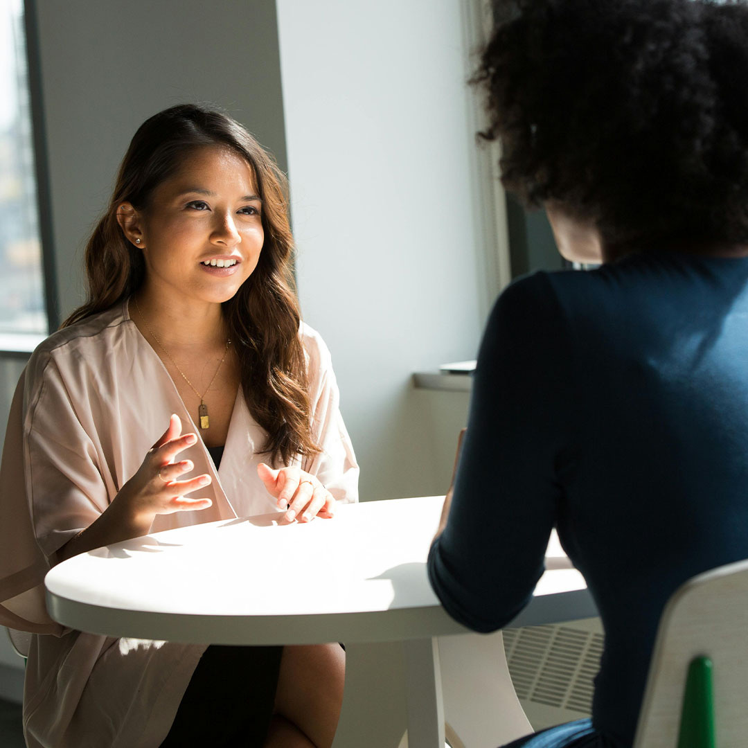 student in academic advising at table with advisor