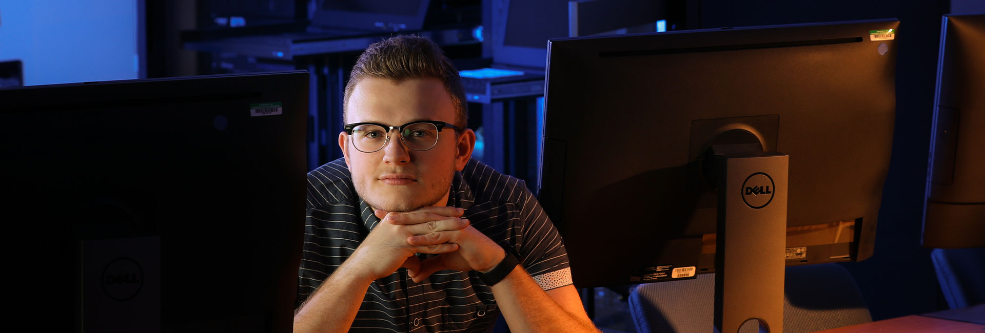 Student at desk infront of monitors