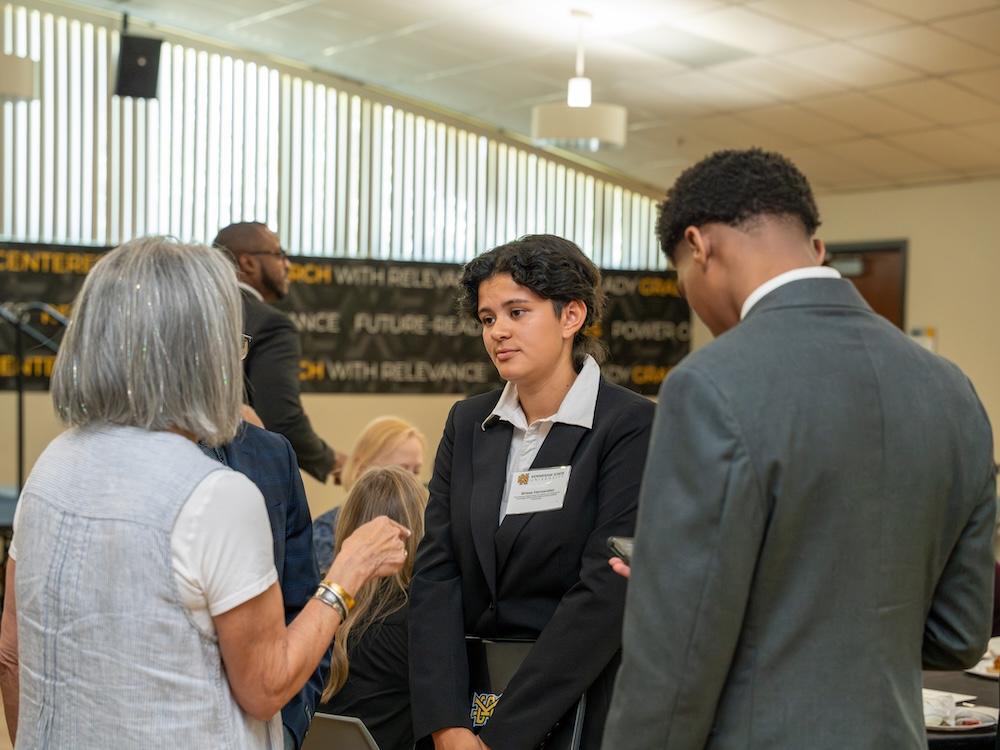  / Brissa Hernandez speaking with donors. 
