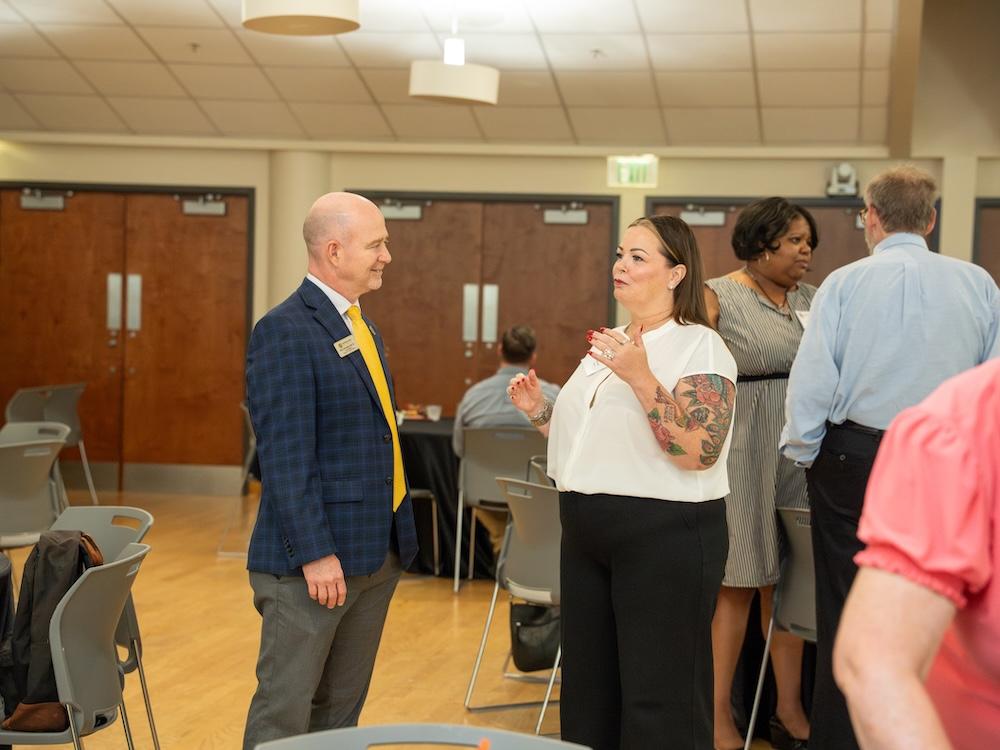  / Dr. Eric Arneson speaking with a donor.