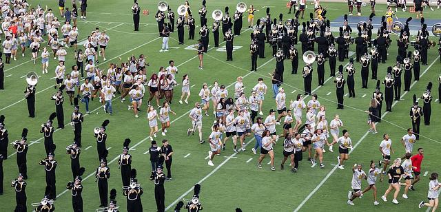 FLIGHT runout of students running across the football field