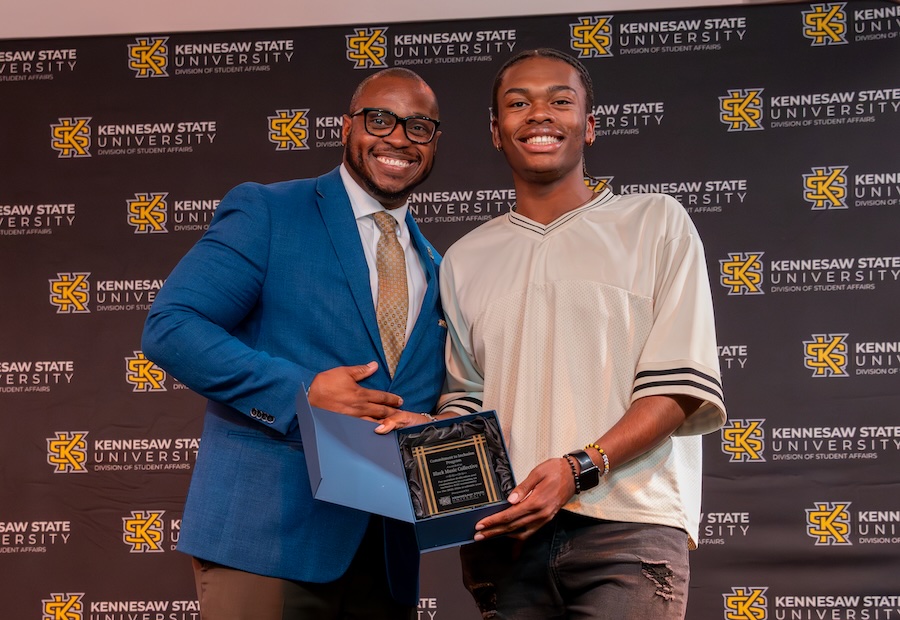 Dr. Ron Briggs giving student of Black Musicians Coalition an award