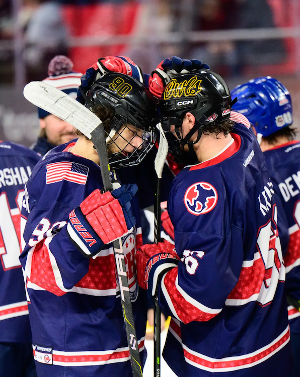 Club hockey players tapping helmets