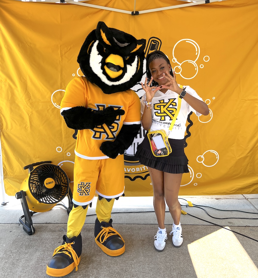 Deshiya Anthony posing with Scrappy the Owl Mascot