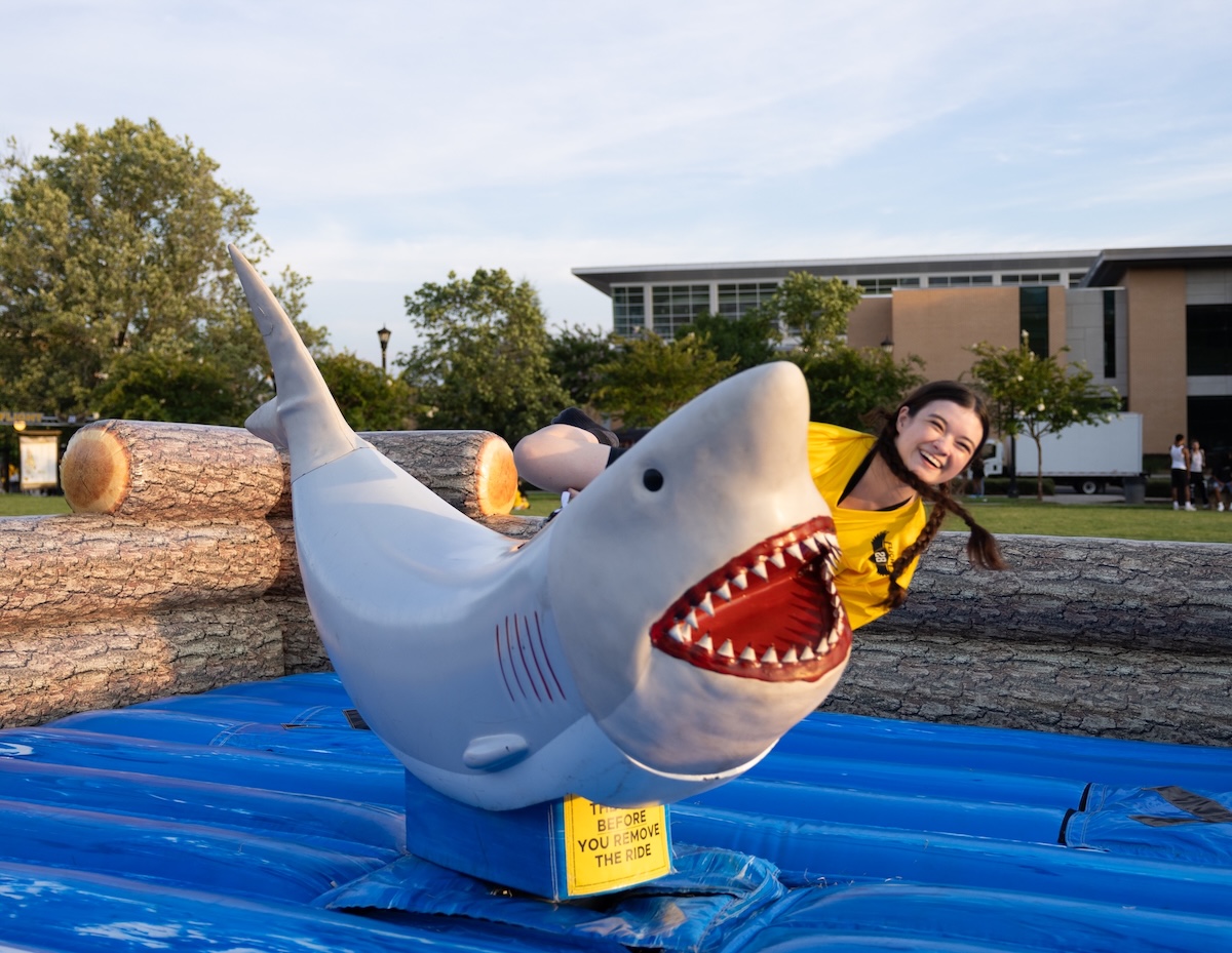 Kail-lin riding a shark at Splash Bash