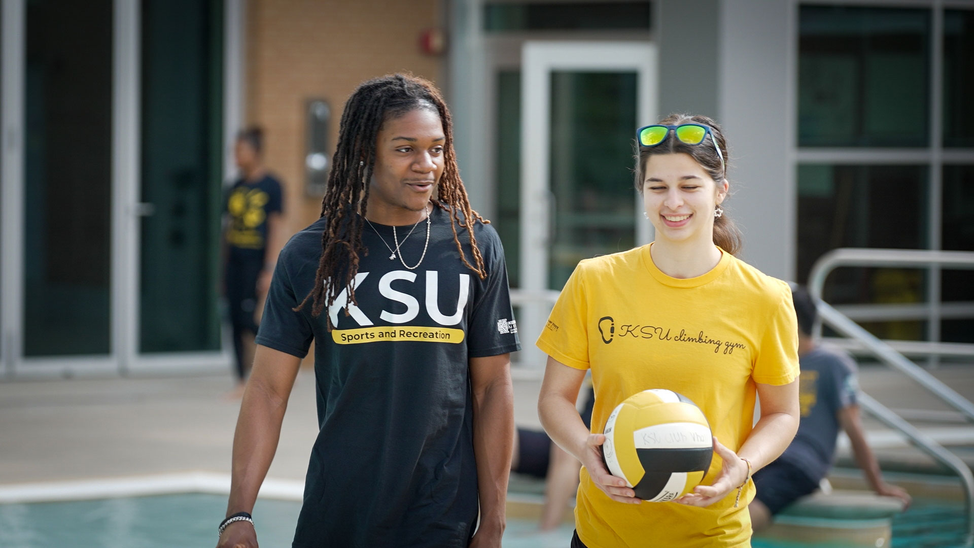Students walking by outdoor pool