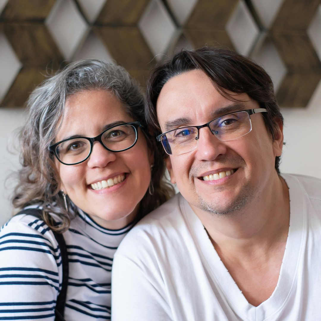 husband and wife smiling next to eachother