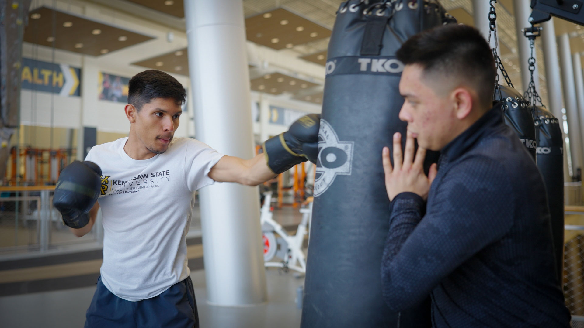 Students using punching bag