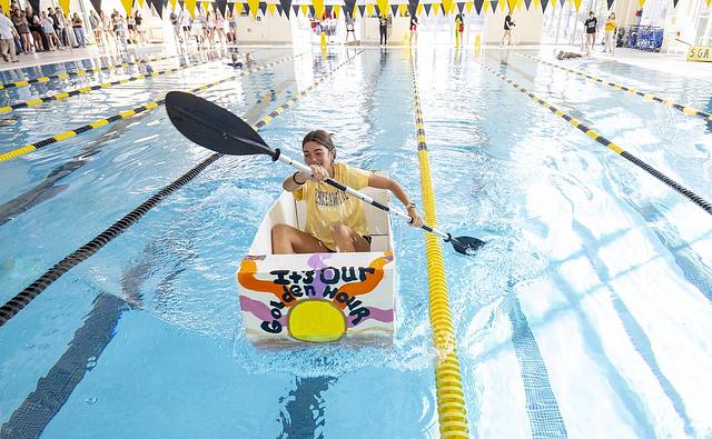 girl rowing her self made boat in the swimming pool