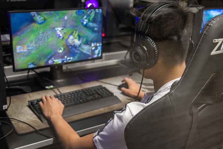 student playing a video game on a PC