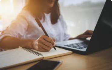 student using their laptop to look for resources.