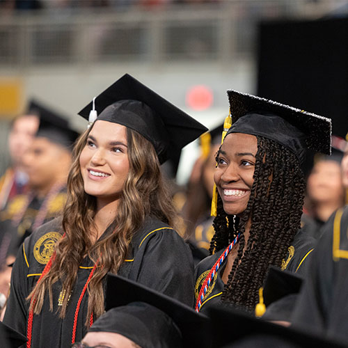 Image of students at the graduation ceremony in full regailia.