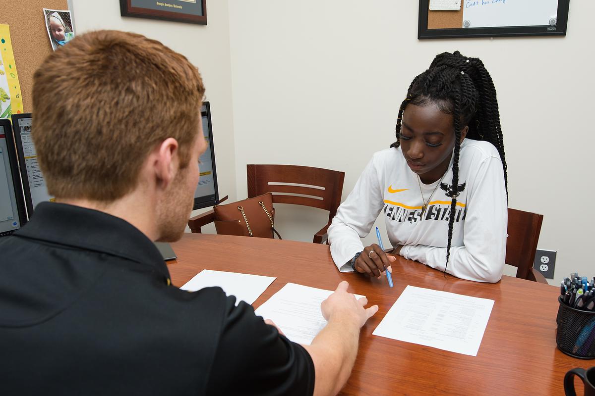 An advisor and a student sit down together to create a plan