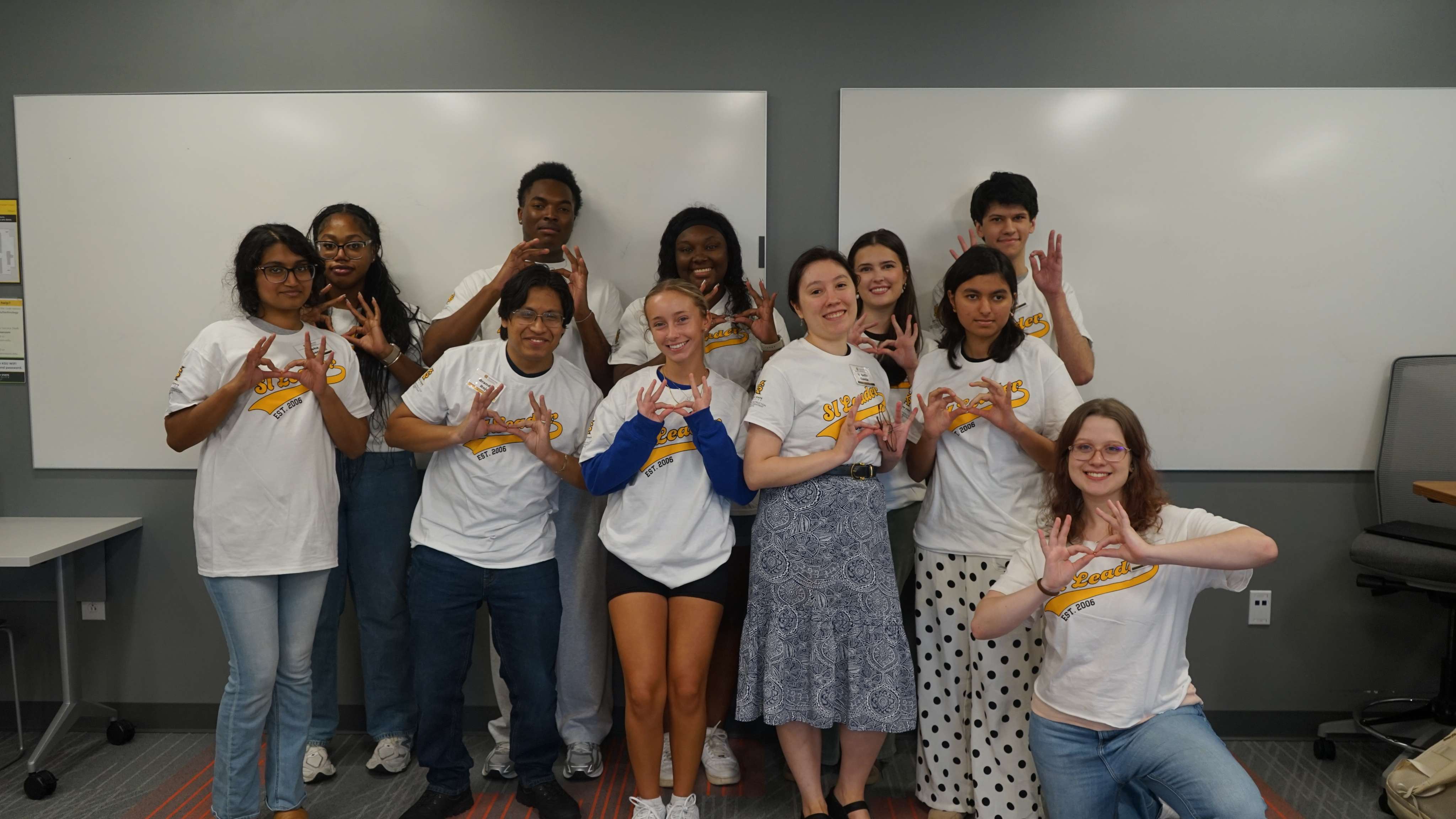 SI Leaders holding up owl eyes