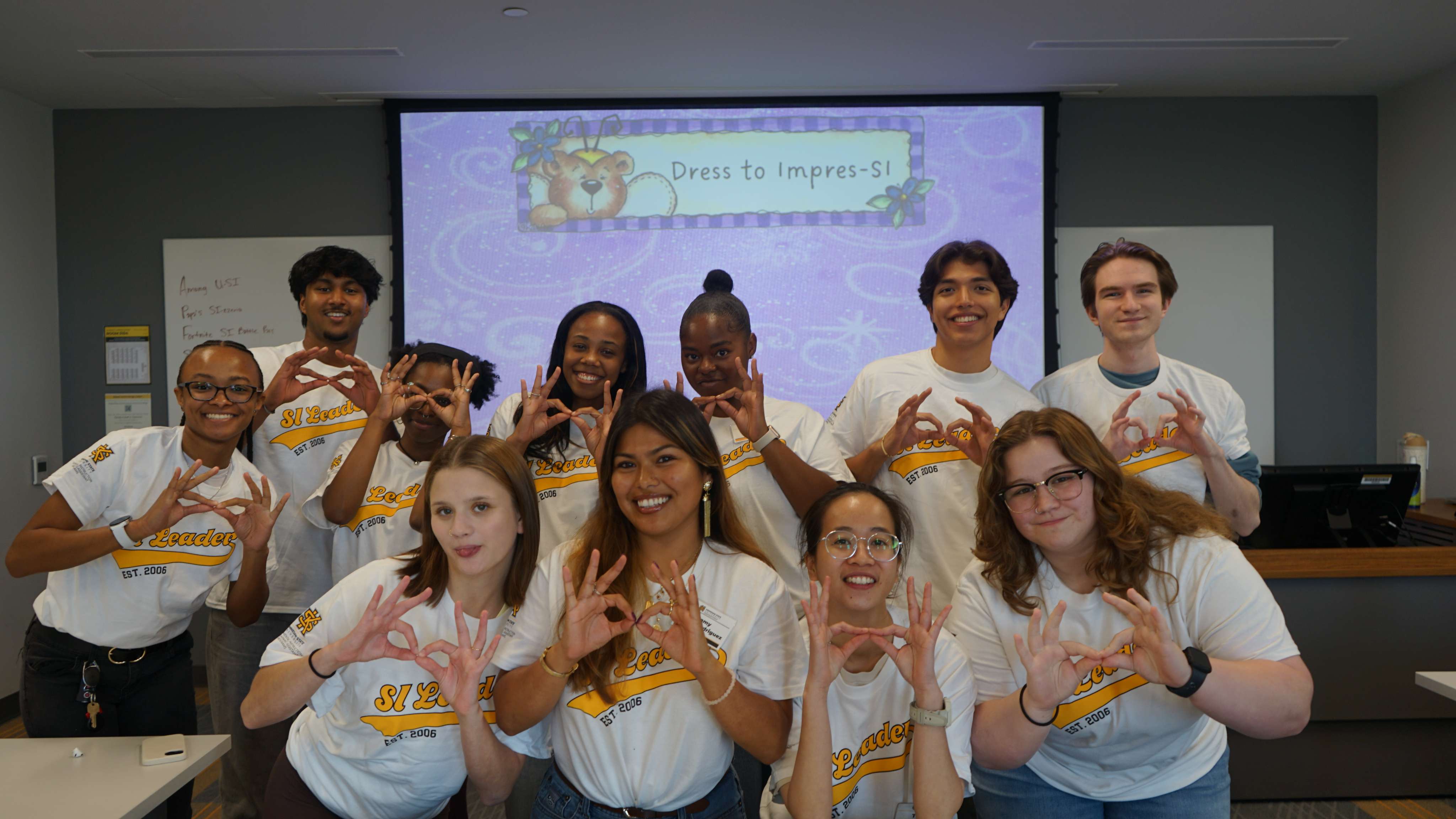 SI Leaders holding up owl eyes