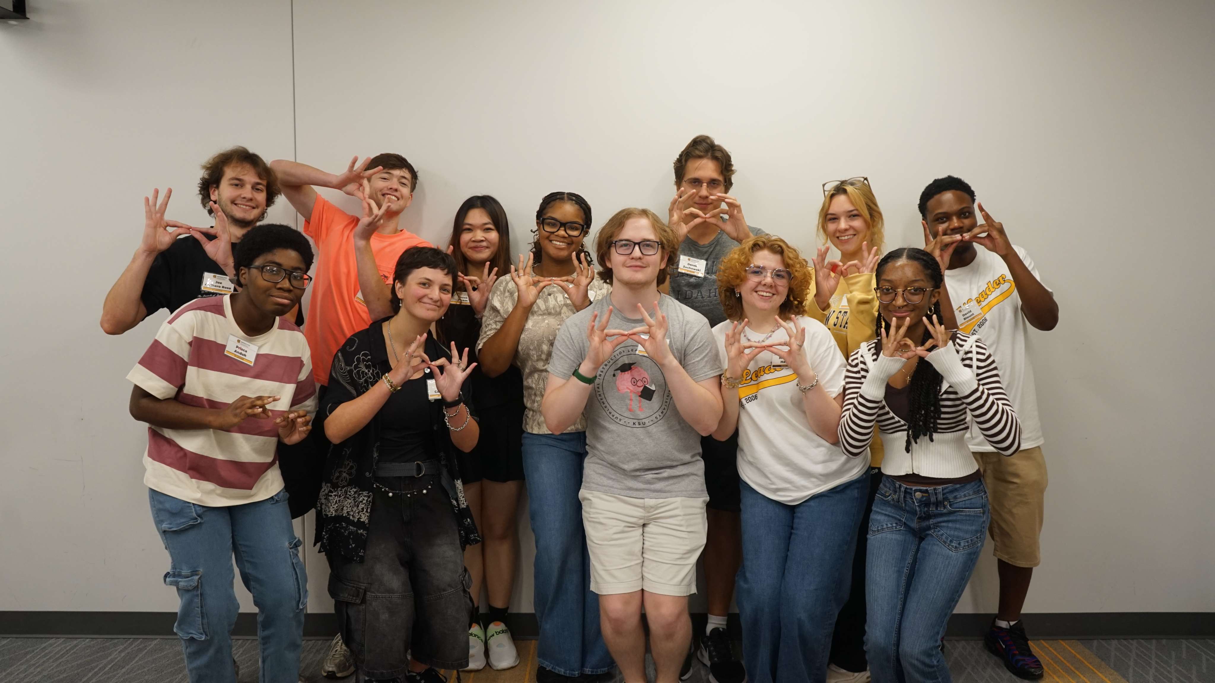 SI Leaders holding up owl eyes