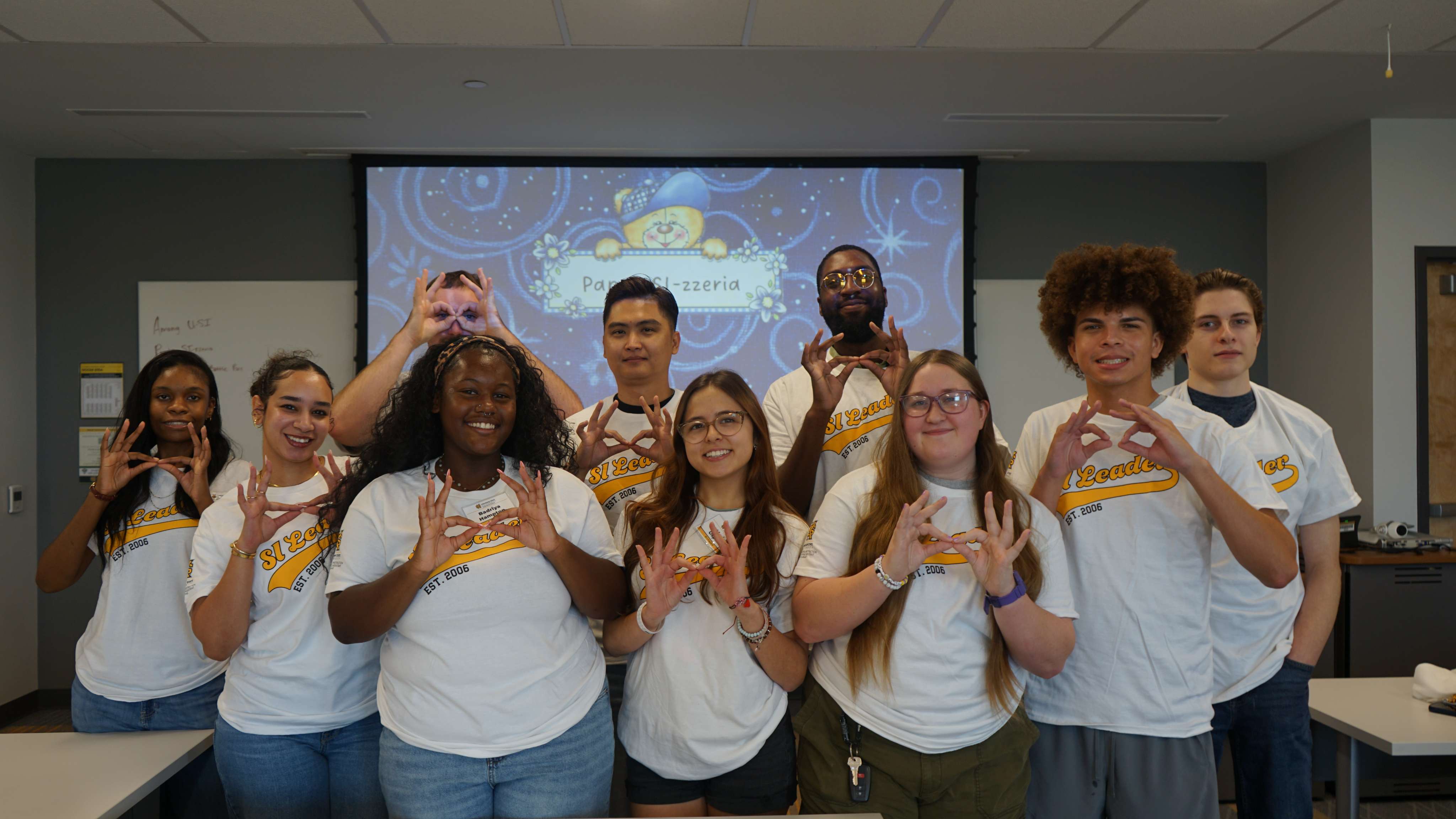 SI Leaders holding up owl eyes